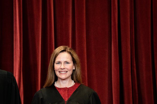 Associate Justice Amy Coney Barrett stands during a group photo of the Justices at the Supreme Court in Washington, DC on April 23, 2021. (Erin Schaff\/The New York Times) Credit: Erin Schaff \/ Pool via