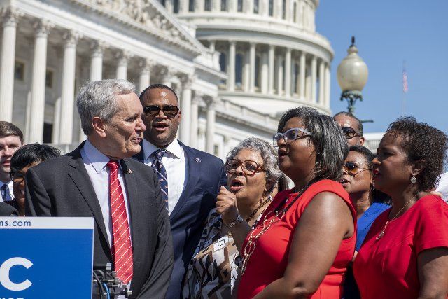 United States Representative Lloyd Doggett (Democrat of Texas), left, and United States Representative Marc Veasey (Democrat of Texas), second from left, join Texas State Representative Senfronia Thompson (D-District 141), dean of the Texas House of Representatives, third from right, as she leads the the group in the song âWe Shall Overcome) during a press conference on voting rights outside the US Capitol in Washington, DC, Tuesday, July 13, 2021. In an effort to block Republicans from enacting new voting restrictions, these Texas state House of Representatives arrived at Dulles International Airport last evening after fleeing their state in a pair of charter jets. Credit: Rod Lamkey 