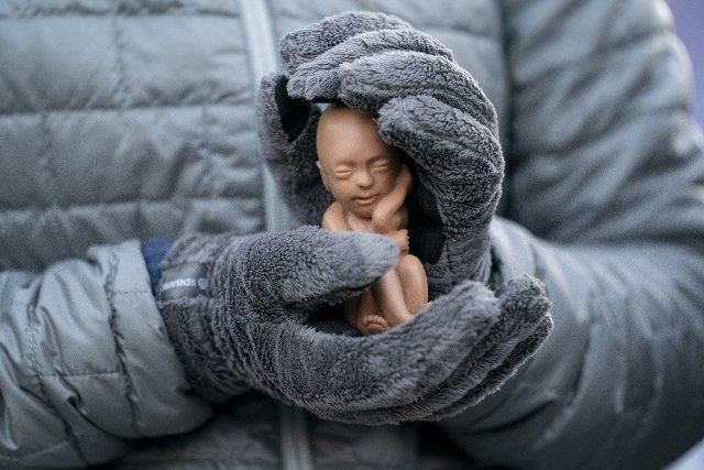 A Pro-Life activist holds a fetus doll outside the United States Supreme Court in Washington DC on Wednesday, December 1, 2021. Supreme Court Justices heard oral arguments on Dobbs v. Jackson Women\