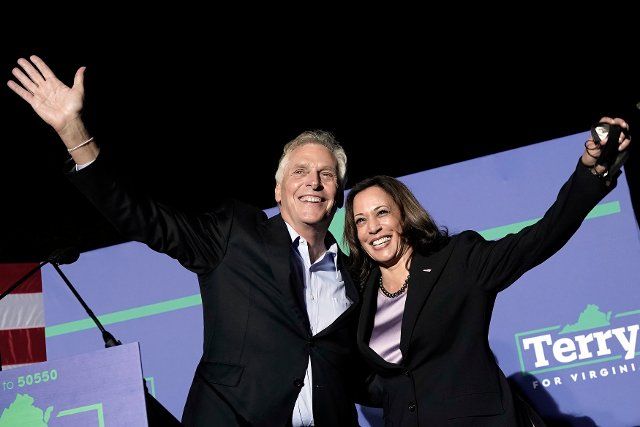 United States Vice President Kamala Harris, right, and Terry McAuliffe, the Democratic Party nominee for Governor of Virginia, left, wave to the crowd at his campaign event in Dumfries, Virginia on Thursday, October 21, 2021. Credit: Yuri Gripas \/ Pool via