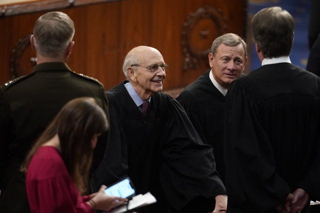 Stephen Breyer, associate justice of the U.S. Supreme Court, from left, John Roberts, chief justice of the U.S. Supreme Court, and Brett Kavanaugh, associate justice of the U.S. Supreme Court, speak during the State of the Union address by U.S. President Joe Biden at the U.S. Capitol in Washington, D.C., U.S., on Tuesday, March 1, 2022. Biden\