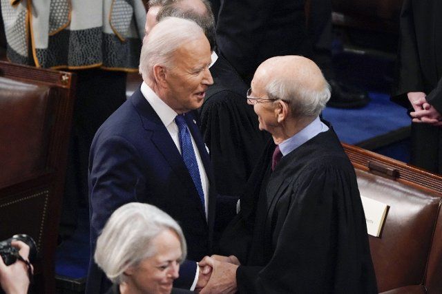 President Joe Biden greets retiring Supreme Court Associate Justice Stephen Breyer before he delivers his first State of the Union address to a joint session of Congress, at the Capitol in Washington, Tuesday, March 1, 2022. Credit: J. Scott Applewhite \/ Pool via