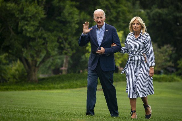 United States President Joe Biden and First Lady Jill Biden walk on the South Lawn of the White House after arriving on Marine One in Washington, D.C., US, on Monday, Aug. 8, 2022. Biden resumed official travel today for the first time since his bout with Covid-19, traveling to Kentucky to show federal support for the state\