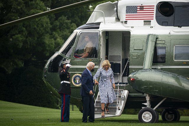 United States President Joe Biden helps First Lady Jill Biden off Marine One on the South Lawn of the White House in Washington, D.C., US, on Monday, Aug. 8, 2022. Biden resumed official travel today for the first time since his bout with Covid-19, traveling to Kentucky to show federal support for the state\