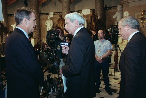 1\/19\/99 STATE OF THE UNION--In Statuary Hall Sen. John Breaux D-La. left steps into the picture as Bob Barr R-Ga. steps out for an interview on Fox after President Bill Clinton\