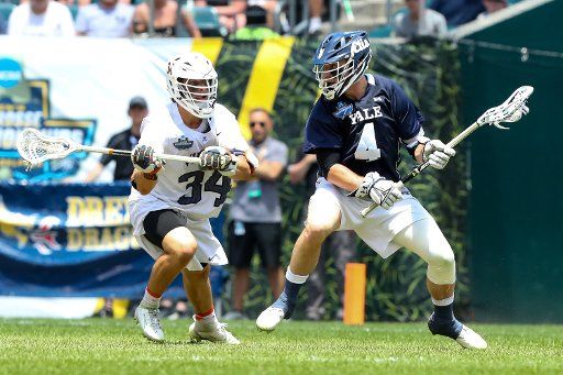 May 27, 2019: Yale Bulldogs midfielder John Daniggelis #4 controls the ball as Virginia Cavaliers midfielder John Fox #34 defends during the first half in the NCAA Division I Men\