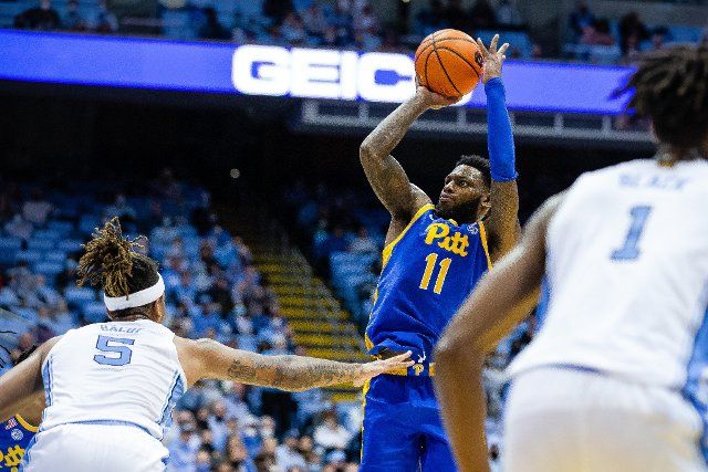 February 16, 2022: Pittsburgh Panthers guard Jamarius Burton (11) pulls up for a jump shot over North Carolina Tar Heels forward Armando Bacot (5) during the second half of the ACC basketball matchup at Dean Smith Center in Chapel Hill, NC. (Scott Kinser\/Cal Sport Media
