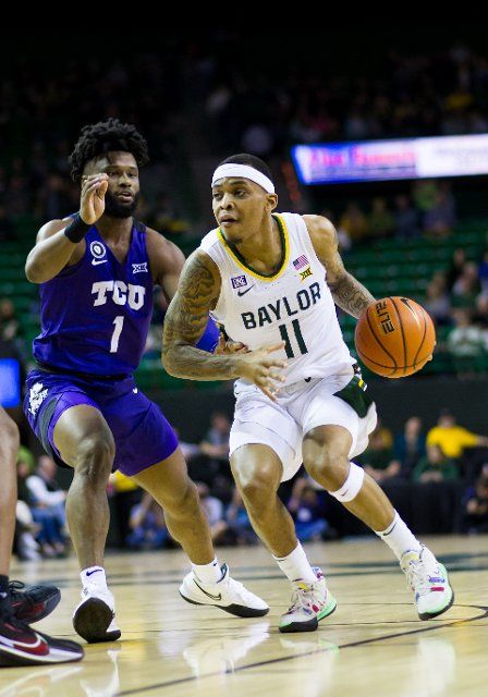February 19 2022: Baylor Bears guard James Akinjo (11) drives on TCU Horned Frogs guard Mike Miles (1) during the 1st half of the NCAA Basketball game between the TCU Horned Frogs and Baylor Bears at Ferrell Center in Waco, Texas. Matthew Lynch