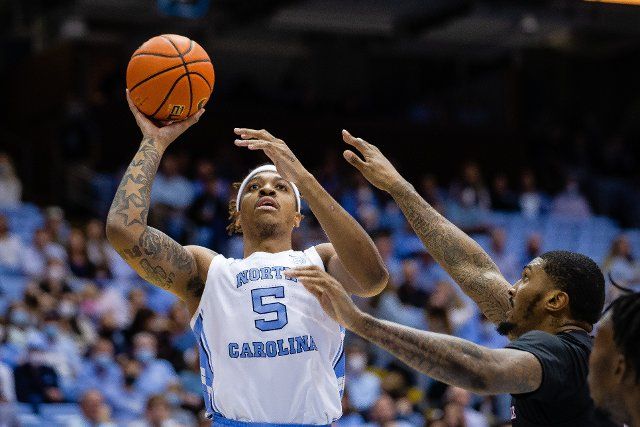 February 21, 2022: North Carolina Tar Heels forward Armando Bacot (5) goes for a short jump shot against the Louisville Cardinals during the first half of the ACC basketball matchup at Dean Smith Center in Chapel Hill, NC. (Scott Kinser\/Cal Sport Media