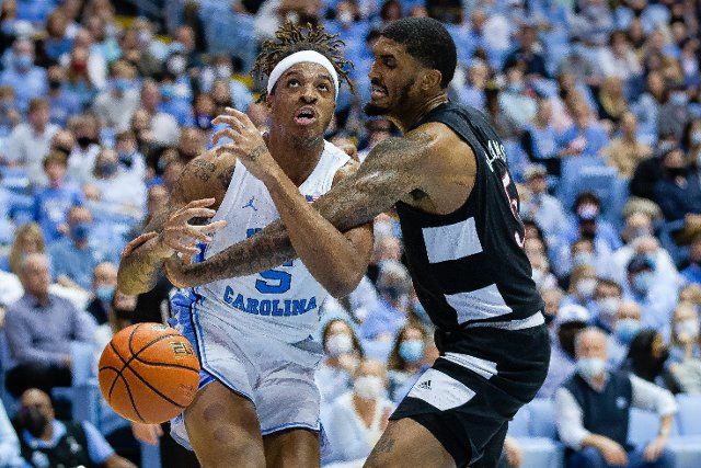 February 21, 2022: North Carolina Tar Heels forward Armando Bacot (5) has the ball knocked away by Louisville Cardinals forward Malik Williams (5) during the first half of the ACC basketball matchup at Dean Smith Center in Chapel Hill, NC. (Scott Kinser\/Cal Sport Media
