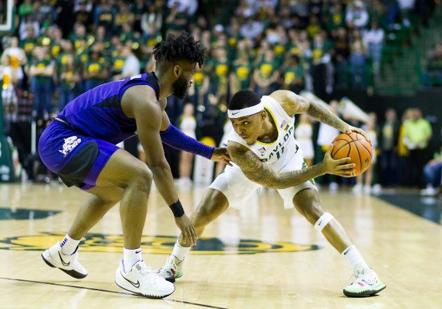 February 19 2022: Baylor Bears guard James Akinjo (11) holds the ball against TCU Horned Frogs guard Mike Miles (1) during the 2nd half of the NCAA Basketball game between the TCU Horned Frogs and Baylor Bears at Ferrell Center in Waco, Texas. Matthew Lynch