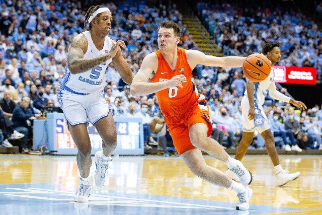February 28, 2022: North Carolina Tar Heels forward Armando Bacot (5) follows Syracuse Orange forward Jimmy Boeheim (0) as he drives to the basket during the second half of the ACC basketball matchup at Dean Smith Center in Chapel Hill, NC. (Scott Kinser\/Cal Sport Media