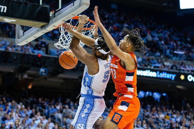 February 28, 2022: North Carolina Tar Heels forward Armando Bacot (5) gets fouled by Syracuse Orange forward Benny Williams (13) as he dunks during the first half of the ACC basketball matchup at Dean Smith Center in Chapel Hill, NC. (Scott Kinser\/Cal Sport Media