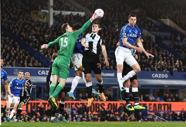 March 17, 2022, Liverpool, United Kingdom: Liverpool, England, 17th March 2022. Asmir Begovic of Everton (L) punches clear from Chris Wood of Newcastle United (C) during the Premier League match at Goodison Park, Liverpool. Picture credit should read: Darren Staples 