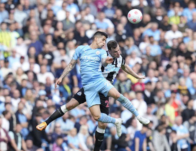 May 8, 2022, Manchester, United Kingdom: Manchester, England, 8th May 2022. Joao Cancelo of Manchester City challenges Chris Wood of Newcastle United during the Premier League match at the Etihad Stadium, Manchester. Picture credit should read: Andrew Yates 