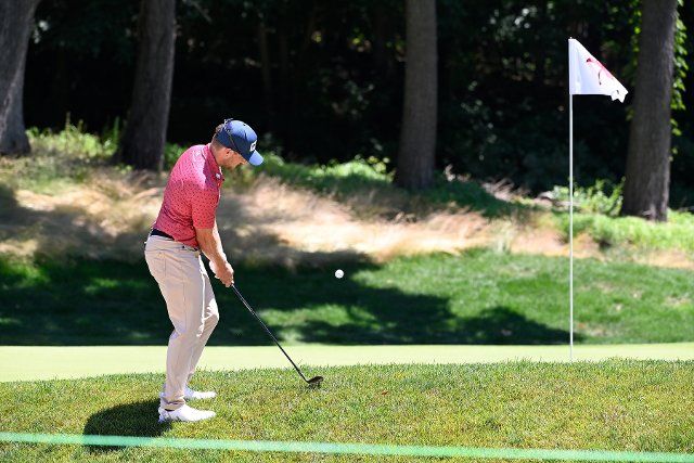 June 25, 2022: Austin Cook, of Jonesboro, AR, chips to the 14th green during the third round of the PGA Travelers Championship golf tournament held at TPC River Highlands in Cromwell CT. Mandatory Credit Eric Canha\/Cal Sport