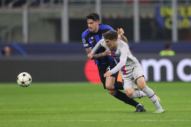 October 4, 2022, Milan, United Kingdom: Milan, Italy, 4th October 2022. Alessandro Bastoni of FC Internazionale tussles with Gavi of FC Barcelona during the UEFA Champions League Group C match at Giuseppe Meazza, Milan