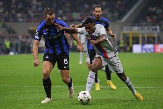 October 4, 2022, Milan, United Kingdom: Milan, Italy, 4th October 2022. Ansu Fati of FC Barcelona holds off Stefan de Vrij of FC Internazionale as he breaks into the penalty area with the ball during the UEFA Champions League Group C match at Giuseppe Meazza, Milan