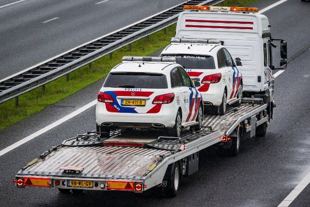 Police cars are transported on a trailer. ANP \/ Hollandse Hoogte Venema Media netherlands out - belgium