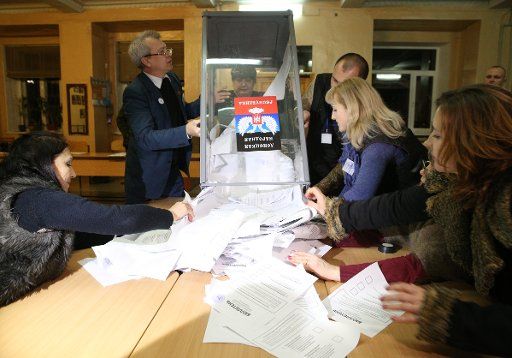Members of an electoral commission count votes after the presidential and parliamentary elections of the Donetsk People\