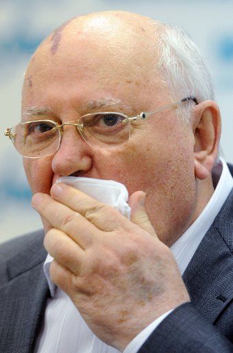 Former president of the Soviet Union Mikhail Gorbachev covers his mouth with a handkerchief during a press conference at the Moscow office of Interfax news agency. The event marks the 20th anniversary of the 1991 coup-d\