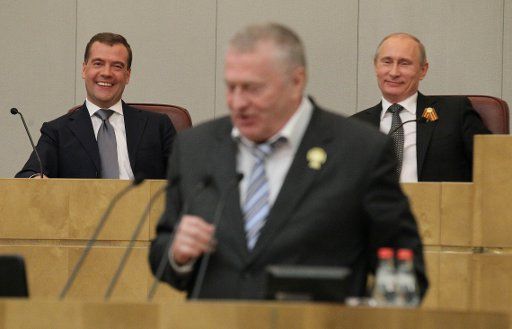 Premiership candidate Dmitry Medvedev (front) speaks at a special State Duma plenary meeting. Pictured L-R background: President of Russia Vladimir Putin and State Duma chairman Sergei Naryshkin. Pictured L-R background: premiership candidate Dmitry ...