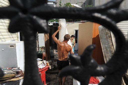 Flood victims dry a mattress and furniture in their yard after a massive flood. Divnomorsk, Russia, July 8, 2012. Photo by Sergei Karpov\/Itar-Tass\/ABACAPRESS.COM