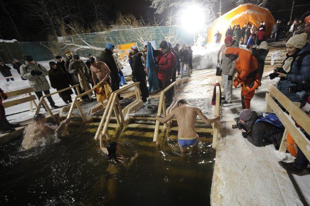 People take a dip in an ice hole in Serebryany Bor forest park, on the eve of the Feast of Theophany (Epiphany) in Moscow, Russia on January 18, 2013. Photo by Sergei Bobylev\/Itar-Tass\/ABACAPRESS.COM
