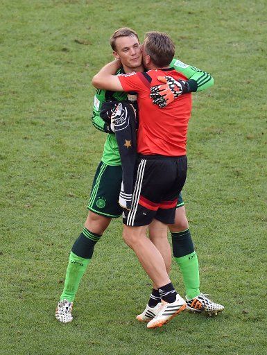 Goalkeeper coach Andreas Koepke (R) of Germany hugs goalkeeper Manuel Neuer after the FIFA World Cup 2014 quarter final soccer match between France and Germany at Estadio do Maracana in Rio de Janeiro, Brazil, July 4, 2014. Photo by Marcus Brandt\/...
