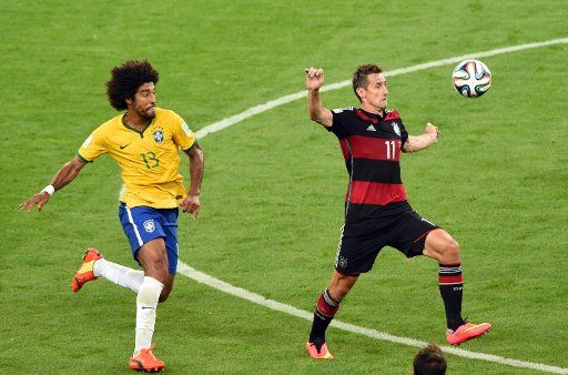 Miroslav Klose (R) of Germany and Dante of Brazil vie for the ball during the FIFA World Cup 2014 semi-final soccer match between Brazil and Germany at Estadio Mineirao in Belo Horizonte, Brazil, July 8, 2014. Photo by Andreas Gebert\/DPA\/ABACAPRESS....