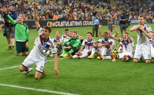 Thomas Mueller of Germany (front) celebrates with his team-mates after winning the FIFA World Cup 2014 final soccer match between Germany and Argentina at the Estadio do Maracana in Rio de Janeiro, Brazil, 13 July 2014. Photo: Andreas Gebert\/dpa \/...