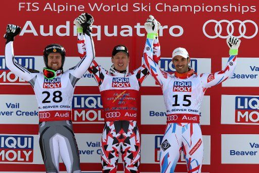 (L-R) Silver medal winner Dustin Cook of Canada, Gold medal winner Hannes Reichelt of Austria and Bronze medal winner Adrien Theaux of France react after the mens Super-G at the Alpine Skiing World Championships in Vail - Beaver Creek, CO, USA, on ...