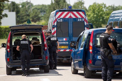 Police stand near the Air Products industrial gas factory in Saint-Quentin Fallavier, France, 27 June 2015. A man was killed in an attack on the factory on Friday. Photo: Marius Becker\/DPA\/ABACAPRESS.