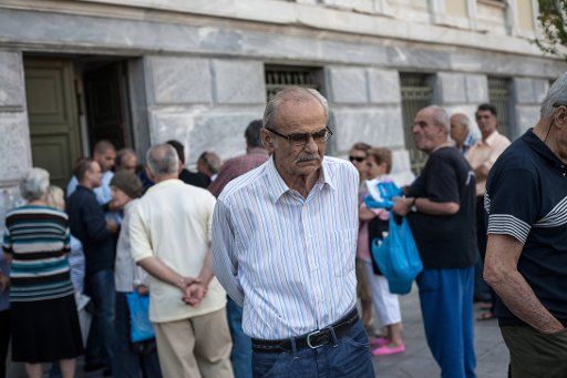 A pensioner waits outside a branch of the National Bank of Greece to get his pension in Athens, Greece on the 29th of June 2015. Photo by Socrates Baltagiannis\/DPA\/ABACAPRESS.