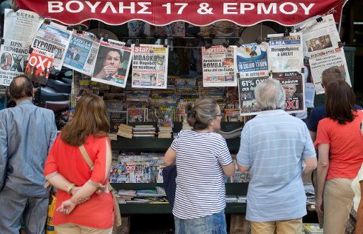 People read front pages of the newspapaers after the referendum in central Athens, Greece, 06 July 2015. The Greek finance minister has resigned following Sunday\