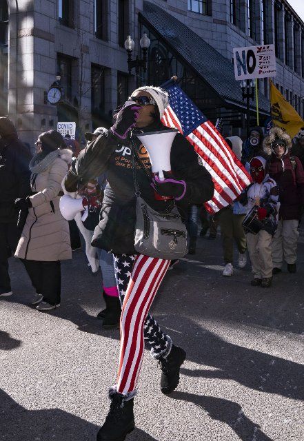 January 15, 2022, Boston, Massachusetts, USA: Trump supporter and a candidate for Massachusetts Secretary of State, Rayla Campbell (R) marches against the COVID-19 vaccine mandate downtown Boston against in Boston. Boston Mayor Michelle Wu announced that showing proof of vaccination against COVID-19 are required upon entering certain indoor spaces in Boston as the citys indoor vaccine mandates takes effect on January 15, 2022. The city also announced that it will require vaccination of all city employees on the same timeline (January 15 for first dose and February 15 for the second dose), unless granted a reasonable accommodation for medical or religious reasons. (Photo by Keiko Hiromi\/AFLO