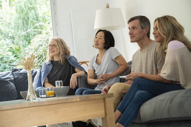 Portrait of diverse group of friends gathered at home to watch a movie