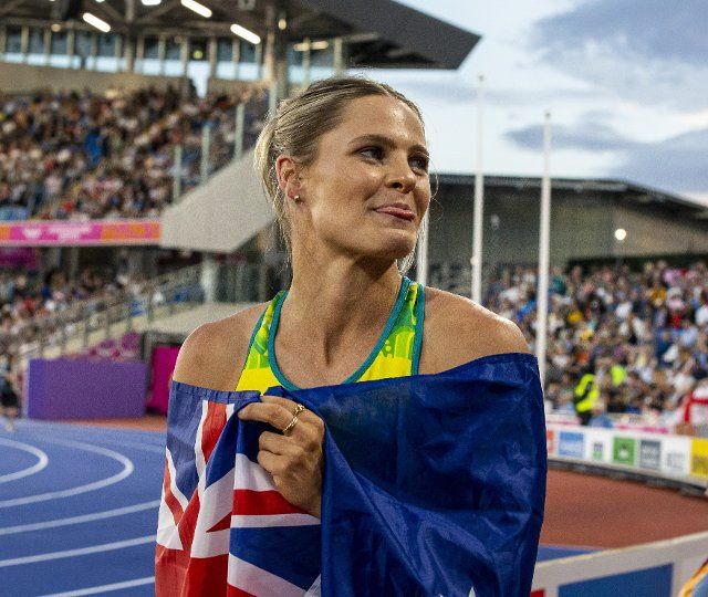 2nd August 2022; Alexander Stadium, Birmingham, Midlands, England: Day 5 of the 2022 Commonwealth Games: Nina Kennedy (AUS) wrapped in her national flag celebrates by sticking her tongue out after winning the Gold Medal in the Pole Vault with a height of 4.60m