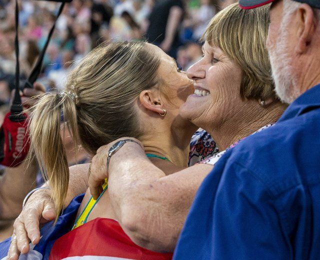 2nd August 2022; Alexander Stadium, Birmingham, Midlands, England: Day 5 of the 2022 Commonwealth Games: Nina Kennedy (AUS) with her national flag celebrates with family after winning the Gold Medal in the Pole Vault with a height of 4