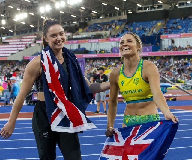 2nd August 2022; Alexander Stadium, Birmingham, Midlands, England: Day 5 of the 2022 Commonwealth Games: Nina Kennedy (AUS) with her national flag celebrates after winning the Gold Medal in the Pole Vault with a height of 4.60m alongside Imogen Ayris (NZL) who won the Bronze Medal with a height of 4