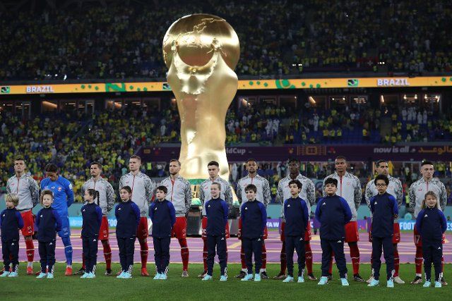 28th November 2022; Stadium 974, Doha, Qatar; FIFA World Cup Football, Brazil versus Switzerland; Switzerland starting eleven with a giant FIFA World Cup trophy behind the