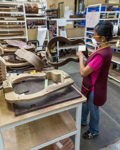 Workers building and assembling guitars at the Taylor Guitar factory in Tecate, Mexico