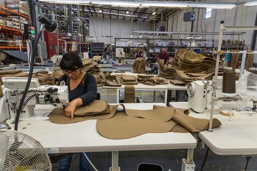 Workers sewing and assembling soft guitar cases at the Taylor Guitar factory in Tecate, Mexico