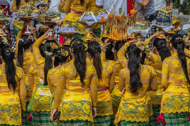 Young women take part in a religious ceremony in Bali