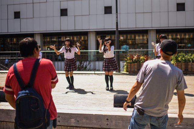 Japanese schoolgirl music band perform for an older male audience in Himeji