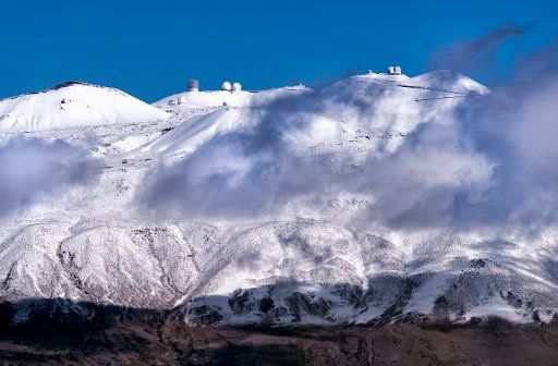 Mauna Kea summit with snow and observatories; Big Island, Hawaii, United States of