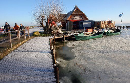 The Bodden harbour is frozen over in Ahrenshoop Germany 29 December 2009. The sun and fog create a beautiful winter scenery. Photo: BERND