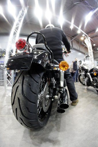 A visitor to Leipzig Motocycle Fair checks out a Harley Davidson Wide Glide in Leipzig Germany 05 February 2010. A total of 220 exhibitors showcase their latest products in motorcycles scooters accesories and equipment from 05 to 07 February ...