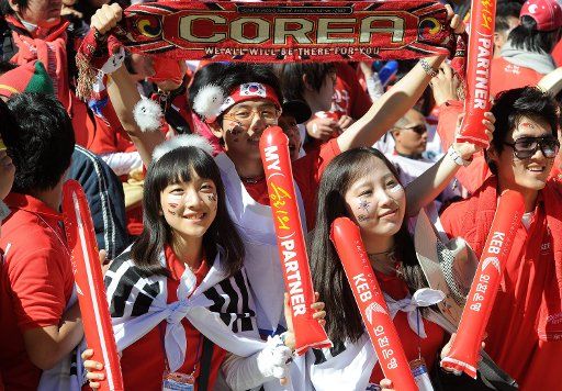 Supporters of South Korea celebrate on the stand prior to the 2010 FIFA World Cup group B match between Argentina and South Korea at Soccer City Stadium in Johannesburg South Africa 17 June 2010. Photo: Achim Scheidemann - Please refer to http:\/\/...