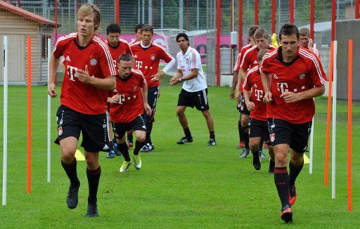 FC Bayern team members Holger Badstuber (L) und Miroslav Klose(R)run during a training session on the club grounds in Munich Germany 2 August 2010. It is the first training in the new season. 11 of the National team players stay in the Bundesliga ...